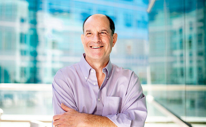 Nobel laureate David Julius standing in front of a glass backdrop